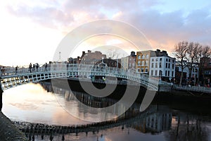 Dublin night scene with Ha`penny bridge and Liffey river lights . Ireland