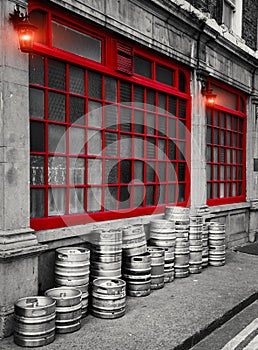 Dublin Street, Row of stacked beer kegs outside of a building. The image shows a part of a traditional pub in Dublin showcasing