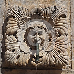 Dubrovnik, Croatia, 08.14.2022. Big fountain of Onofrio. A mascaron is a decorative element in the form of a mask of a