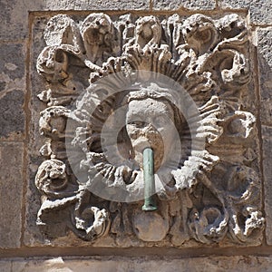 Dubrovnik, Croatia, 08.14.2022. Big fountain of Onofrio. A mascaron is a decorative element in the form of a mask of a