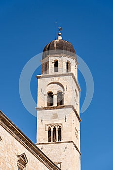 Dubrovnik, Croatia - Aug 20, 2020: Bell tower of Franciscan Church and Monastery in old town in summer