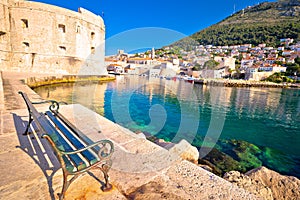 Dubrovnik harbor and city defense walls view from bench