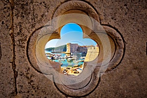 Dubrovnik harbor view from Ploce gate through stone carved detail photo