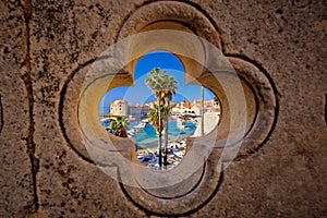 Dubrovnik harbor view from Ploce gate through stone carved detail