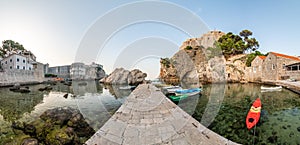 Dubrovnik old city small west harbor with boats. Near is the Lovrijenac fortress. Summer weather, morning soft light. Part of