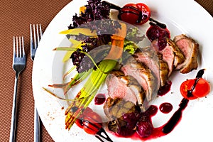 Duck baked with vegetables and herbs