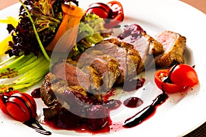 Duck baked with vegetables and herbs
