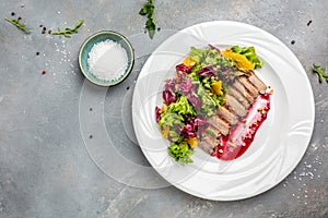 Duck breast, baked duck fillet with berry sauce and salad, banner, menu, recipe place for text, top view