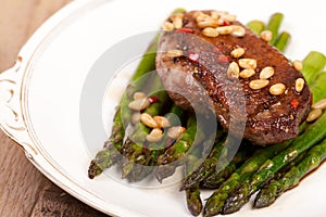 Duck breast with pine nuts and asparagus