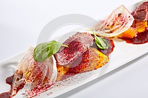 Duck breast with roasted plum dish closeup