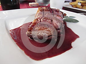 Duck breast on Sangiovese red wine sauce . Italian recipe