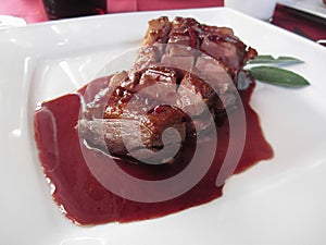 Duck breast on Sangiovese red wine sauce . Italian recipe photo