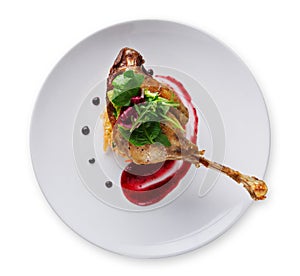 Duck confit with berry sauce isolated on white