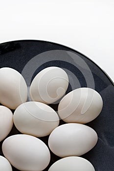 Duck eggs on blue plate on a white background