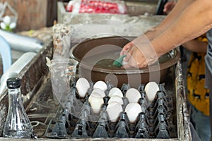 Duck eggs are washed and placed in a tray.