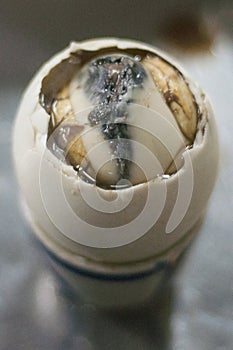 Duck embryo egg in a ceramic cup