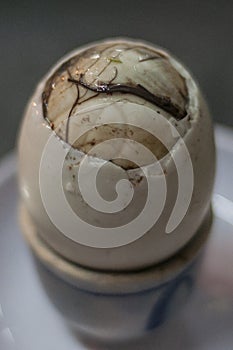 Duck embryo egg in a ceramic cup