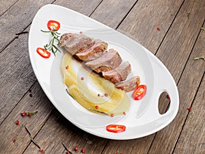 Duck fillet with apple sauce.