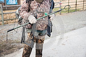 Duck Hunter in Camouflage with Shotgun and Hunting Gear