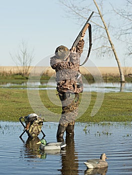 Duck Hunter with gun shooting