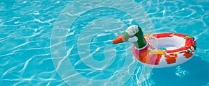 Duck, inflatable circles. Rubber swimming ring on water. Banner