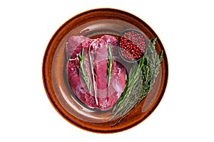 Duck raw breast steaks on rustic plate with rosemary. Isolated on white background.