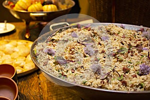 Duck rice with peas and spices in the pan