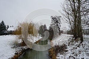 Ducks on the water in winter. Snow in the vicinity of the Wuhle River in January. Marzahn-Hellersdorf, Berlin, Germany.
