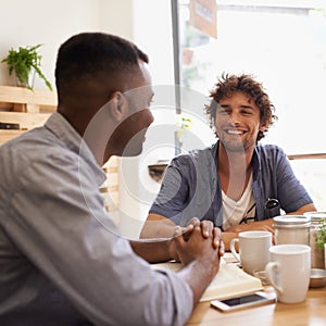 Dude, so how are you doing. Two young men having a conversation while having coffee at a cafe.