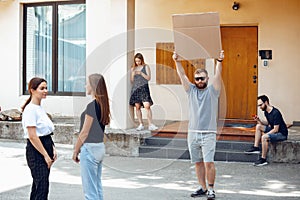 Dude with sign - man stands protesting things that annoy him