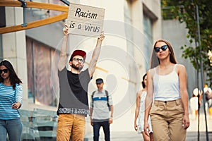 Dude with sign - man stands protesting things that annoy him