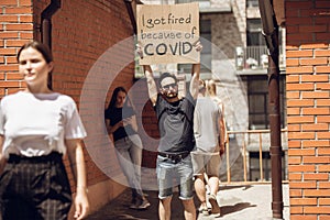 Dude with sign - man stands protesting things that annoy him