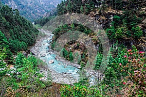 Dudh Koshi snow river in mountain valley in Nepal photo