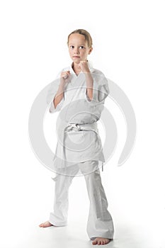 A duduka is standing in a kimano on a white background. Karate is insulated.