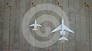 Due to Coronavirus Covid-19 airline fleet parked at the Airport. Aerial drone view of airplanes parked on airport