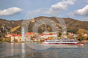 DUERNSTEIN CASTLE AND VILLAGE WITH BOAT ON DANUBE RIVER IN AUSTRIA