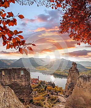 DUERNSTEIN CASTLE AND VILLAGE WITH BOAT ON DANUBE RIVER DURING AUTUMN TIME IN AUSTRIA