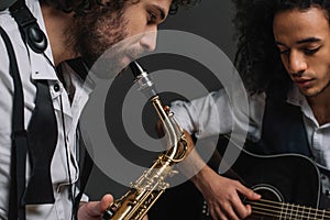 duet of jazzmen playing sax and acoustic guitar