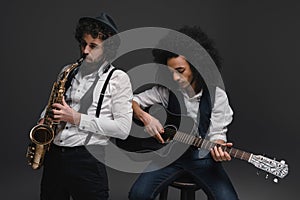 duet of musicians playing sax and acoustic guitar