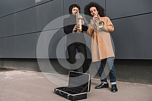 duet of street musicians playing trumpet