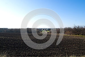 Dug black soil on the field in autumn