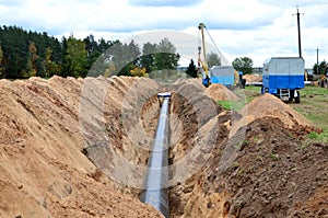 A Dug trench in the ground for the installation and installation of industrial gas and oil pipes