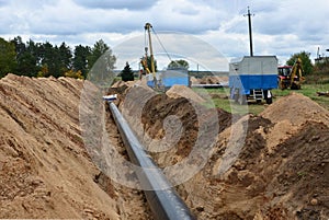 A Dug trench in the ground for the installation and installation of industrial gas and oil pipes.