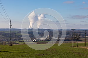 Dukovany nuclear power plant in the Czech Republic, Europe. Smoke cooling towers. There are clouds in the sky. In the foreground
