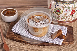 Dulce de leche cake on wooden background