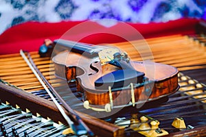 Dulcimer and violin with shallow depth of field and selective focus on the heart of the violin photo
