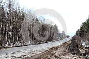 Dull, dirty road in early spring, late autumn or winter in Russia