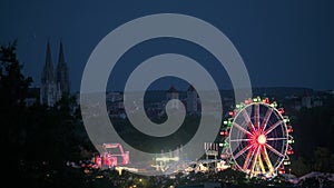 Dult in Regensburg, Bavaria with city skyline in background at night with ferris wheel and all attractions
