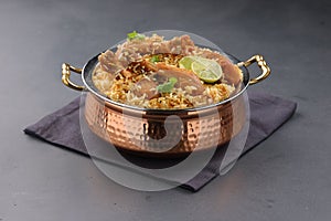 Dum chicken biriyani on a rustic background