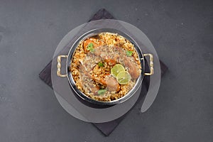 Dum chicken biriyani on a rustic background